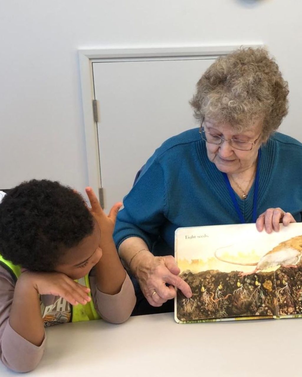 Older adult reading with a child